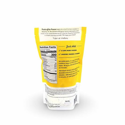 Back view of creamy chicken and rice soup mix packaging with nutritional information on a white background