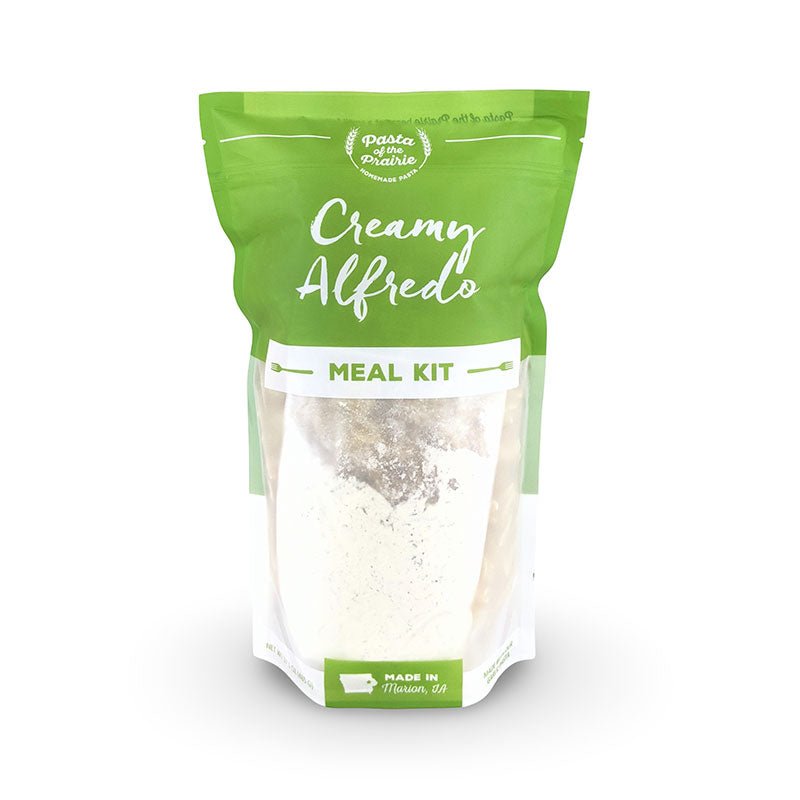 Package of creamy alfredo meal kit on a white background