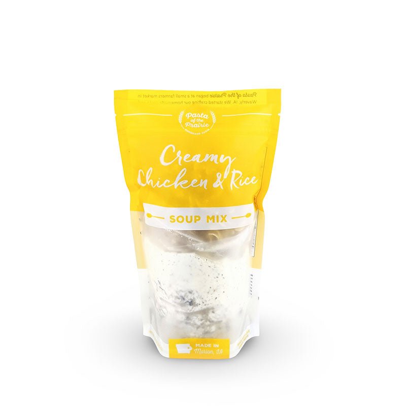 Package of creamy chicken and rice soup mix on a white background