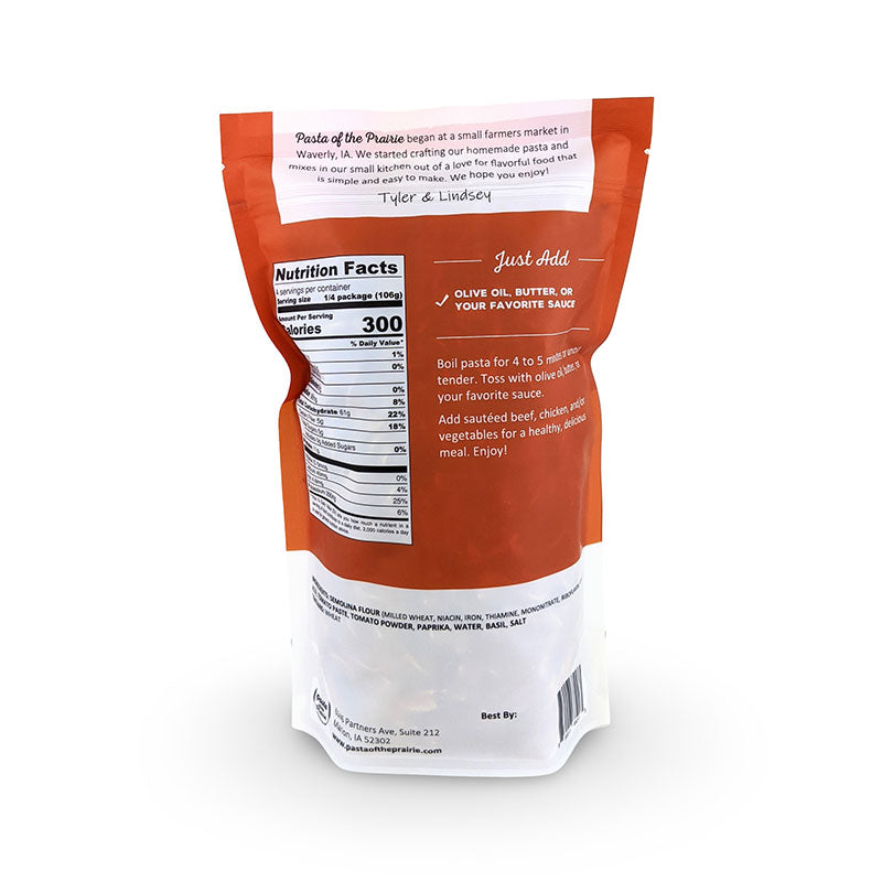 Back view of tomato basil pasta packaging with nutritional information and cooking instructions on a white background